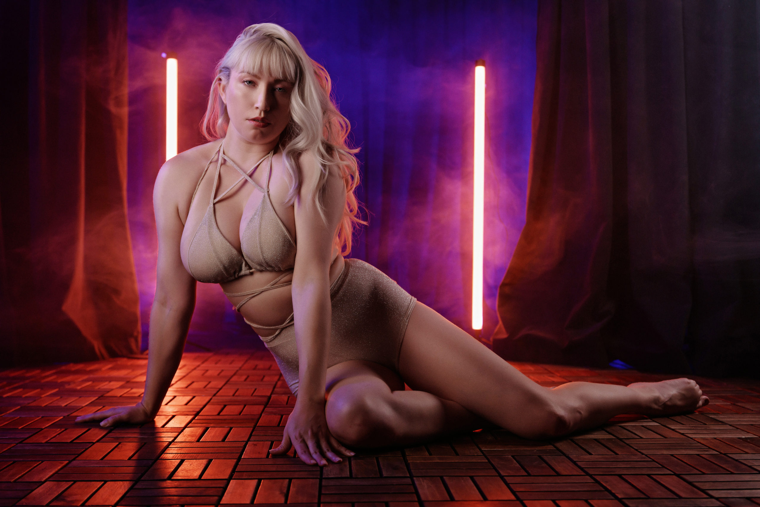 Blonde model Verronica Kirei sits on the floor staring at camera. 